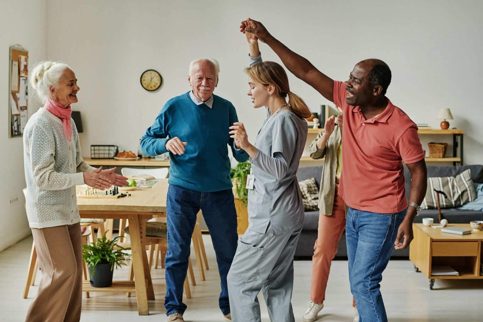 Senior people dancing with their caregiver