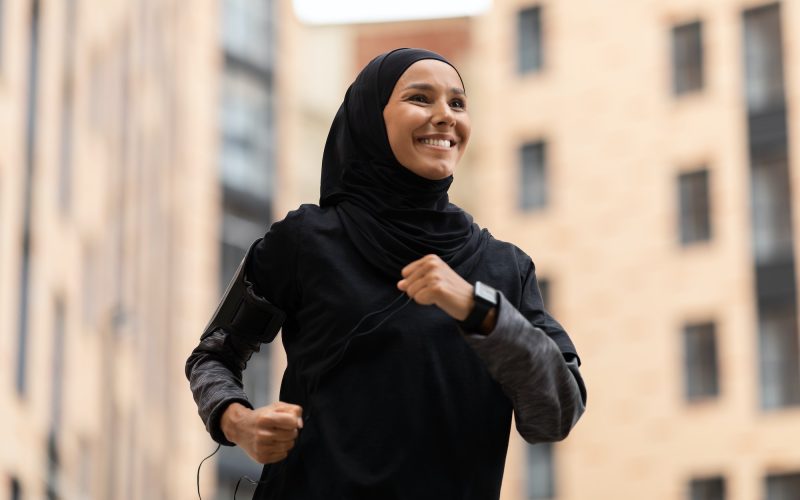 Active Lifestyle. Happy Young Muslim Woman In Modest Sportswear Jogging Outdoors