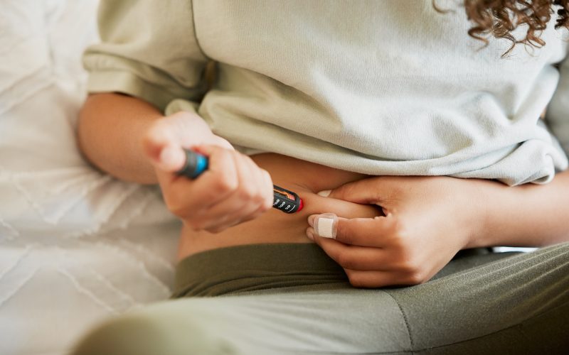 Diabetes, diabetic or woman with a chronic disease injecting herself with insulin treatment at home