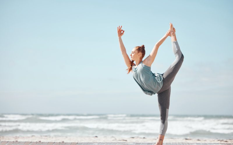 Health, fitness and a yoga with woman meditation pose at a beach, stretching and training workout.